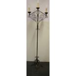 An early 20th Century ecclesiastical style iron candle holder converted for use with electricity, H.