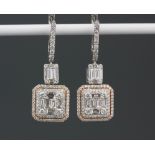 A pair of white and rose metal (tested 18ct gold) drop earrings set with brilliant and baguette