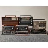 Eight wooden cased vintage portable radios.