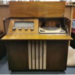 A Fenman radiogram with a box of single LP records, 87 x 78 x 38cm.