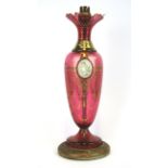 A Bohemian gilt cranberry glass lamp with an inset cameo (needs rewiring), H. 35cm.