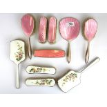 A five piece hallmarked silver and pink enamelled dressing table set together with a further