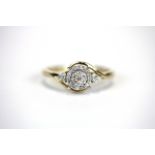 A 9ct yellow gold (stamped 9k) diamond set cluster ring with diamond set shoulders, (P).