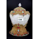 A Tibetan rock crystal and gilt filigree mounted offering jar and cover, inset with red and green