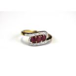 A 9ct yellow gold ring set with three oval cut rubies and diamonds, (M).