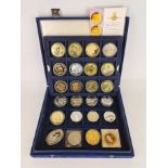 A box of silver and enamalled collectors coins.