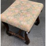 A 1920's carved mahogany upholstered stool.