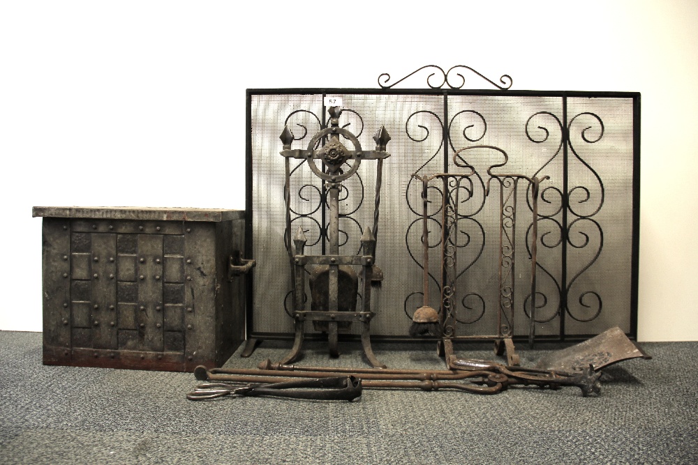 A raw time fire guard with a hammered metal coal box and a quantity of fire side tools.