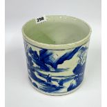 A Chinese hand painted porcelain brush pot decorated with scenes of scholars in a mountain
