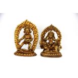 Two small Tibetan gilt bronze figures of Buddhist Deities with detachable flame backgrounds, tallest