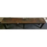 An arts and crafts oak and hammered copper garden bench, cut to fit around a tree or upright post,