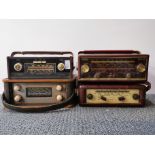 Four vintage portable radios.