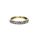 A 9ct yellow and white gold diamond set half eternity ring, (R.5).