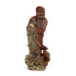 A 19th/early 20th Century Chinese carved soapstone figure of an Arhat.