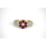 A 9ct yellow gold ruby and diamond set cluster ring, (M).