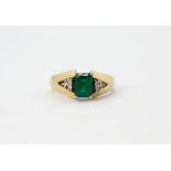 A 14ct yellow gold ring set with an emerald cut green stone and diamond set shoulders, (O.5).