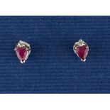 A pair of 14ct white gold stud earrings set with pear cut rubies and diamonds, L. 0.7cm.