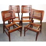 A set of four heavy quality 1970's teak dining chair frames.