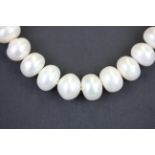 A single row necklace of 11mm cultured pearls, L. 43cm.