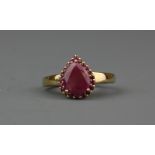 A 9ct yellow gold ring set with pear cut ruby surrounded by rubies, (P).