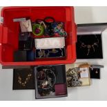 An extensive box of costume jewellery.