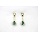 A pair of 9ct yellow gold oval cut emerald set drop earrings, L. 2cm.