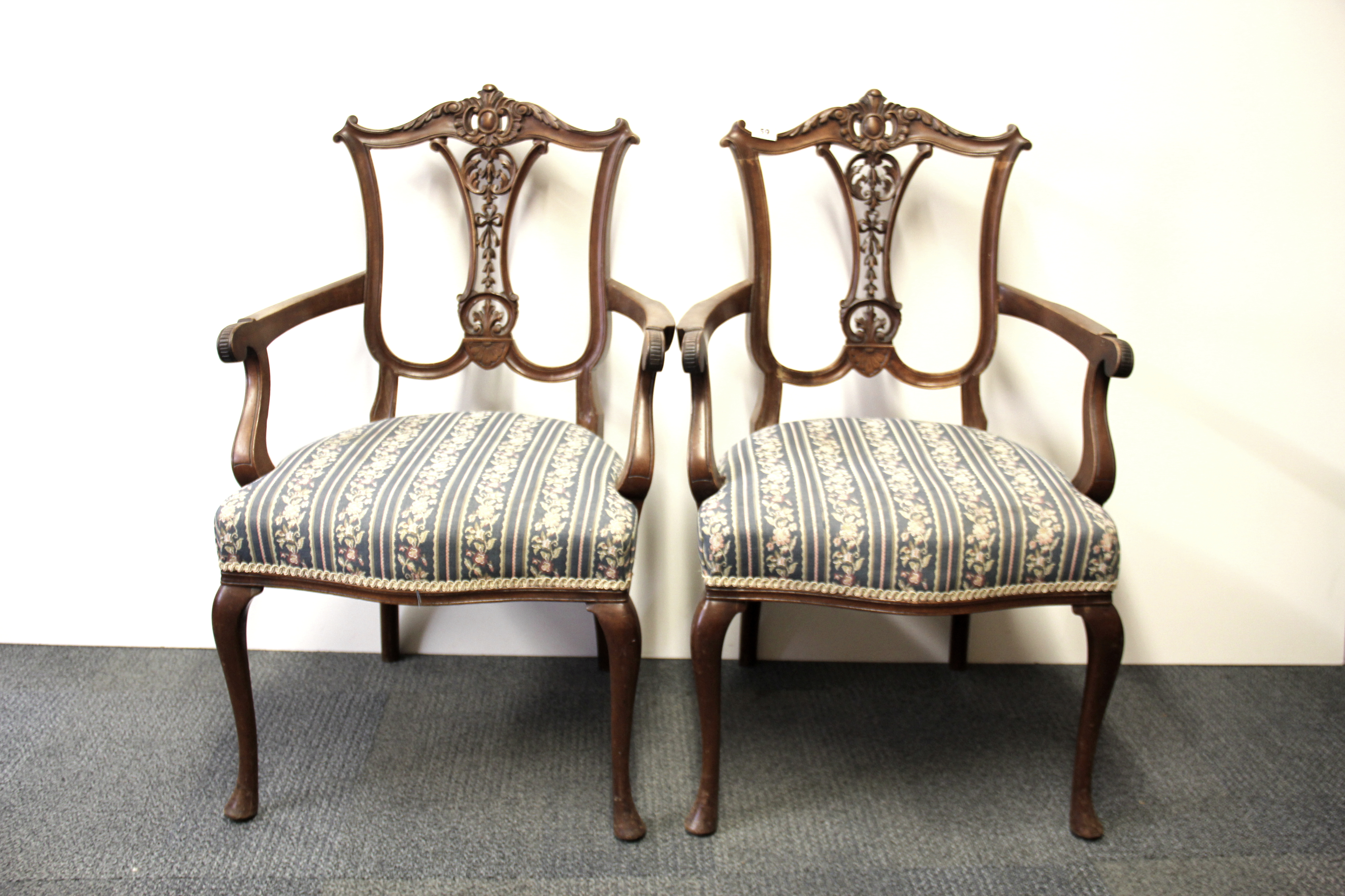 A pair of 19th Century carved beechwood arm chairs.