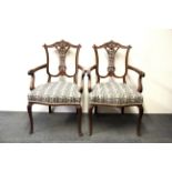 A pair of 19th Century carved beechwood arm chairs.