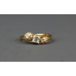 An 18ct yellow gold (stamped 18k) ring set with an approx. 0.50ct baguette cut diamond and brilliant