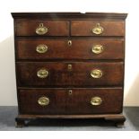 A Georgian oak five drawer chest with a walnut cross banding and brass handles, 102 x 101cm.