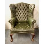 A 1920's balla and claw foot wing back armchair.