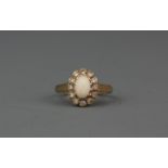 A 9ct yellow gold opal and white stone set cluster ring, (K.5).