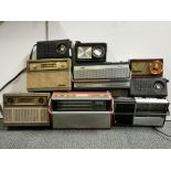 Nine mixed transistor radios.