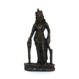A Tibetan bronze figure of a standing Deity with remnants of colour to the crown, H. 7cm.