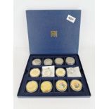 A box of mixed silver, gilt and enamalled coins.