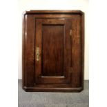 An 18th Century oak corner cabinet with brass escutcheon and key, H. 66cm.