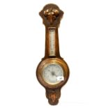 A calved oak wall barometer, H. 62cm.