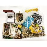 An extensive box of costume jewellery and other items.