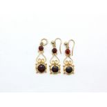 A pair of yellow metal (tested minimum 9ct gold) garnet set drop earrings and matching pendant, L.