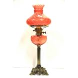 A brass and ruby glass oil lamp, H. 68cm.
