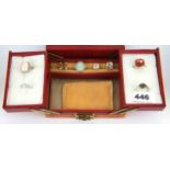 A jewellery box containing eight stone set silver rings.