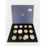 A box of mixed coins and medals.