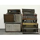 Eight wooden cased vintage transistor radios.