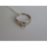 A single stone diamond ring, the princess-cut diamond in four claw crossover mount to plain shank,