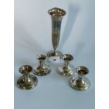 Four silver squat candlesticks with weighted bases, marked Birks Stirling,