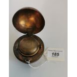 A leather and gilt metal inkwell in the form of a cricket ball.