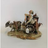 A large musical Capodimonte bisque porcelain figure group of a street musician and his organ with