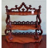 A Victorian serpentine fronted walnut three tier whatnot.