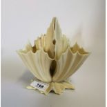 A cream three sectioned Royal Worcester porcelain vase of leaf like form.