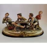 A very large Capodimonte bisque porcelain figure group The Cheats, signed by the artist, 54cm long.